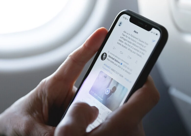 How to Find Deleted Tweets on Twitter - A person is using twitter on phone